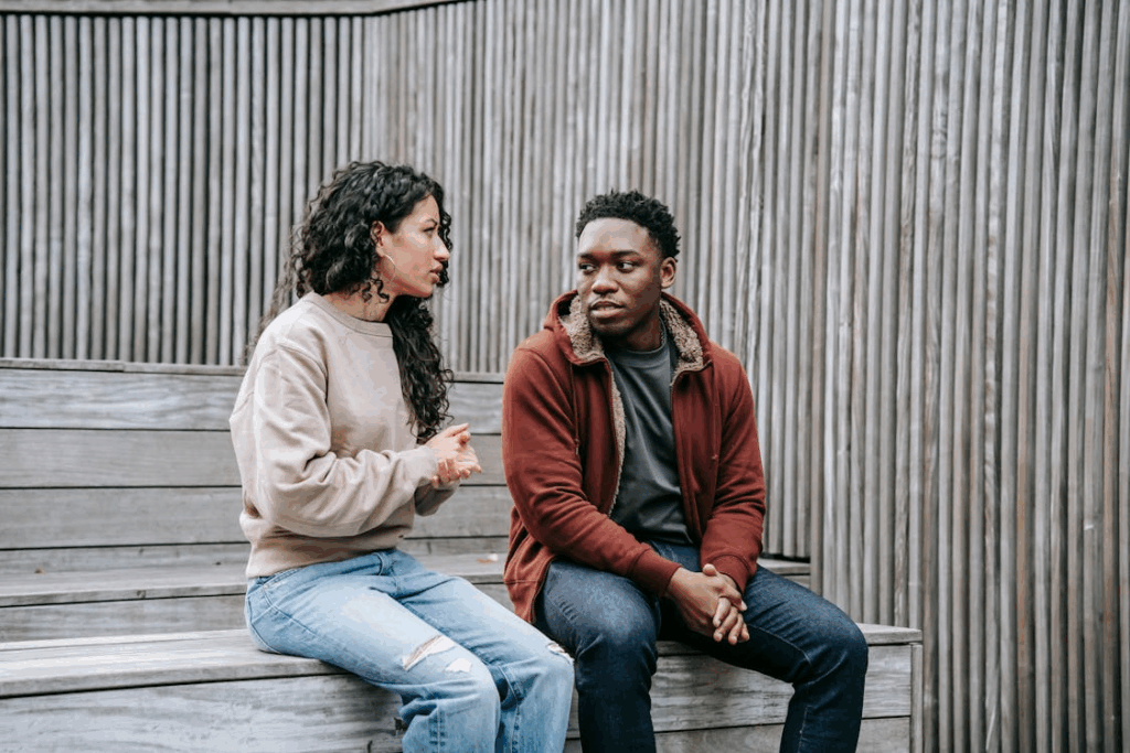 multiethnic couple having conversation on stairs