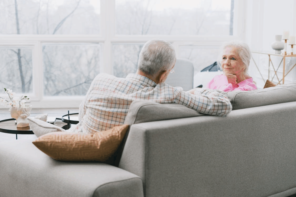Photo of an Elderly Couple Sitting on a Sofa