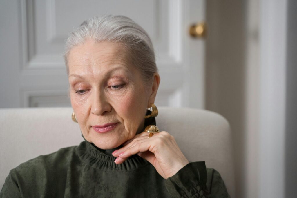 Elderly woman looking thoughtful, showing mood and personality changes.