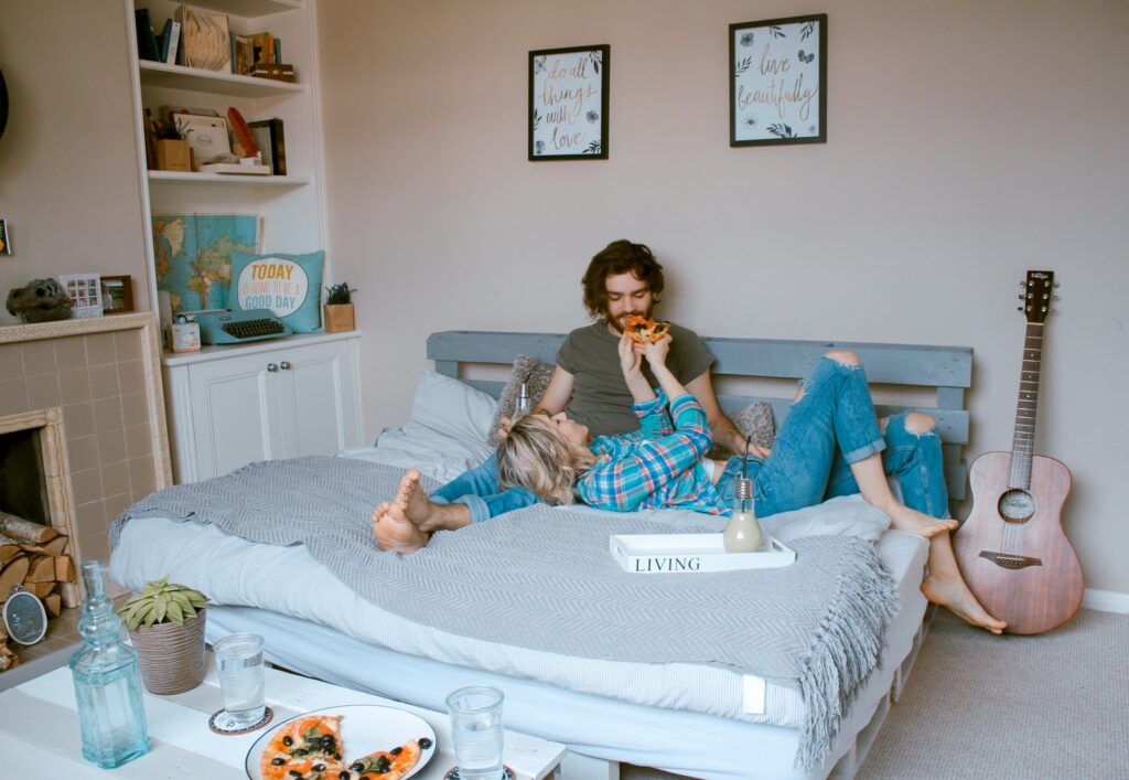 man and woman lying on bed
