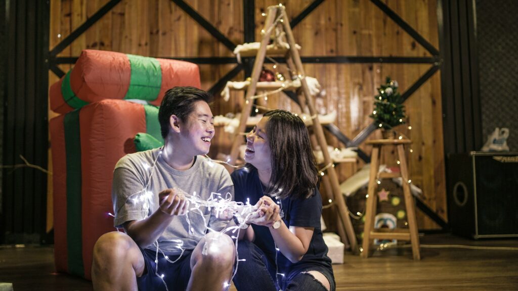 selective focus photography of couple holding lighted string lights
