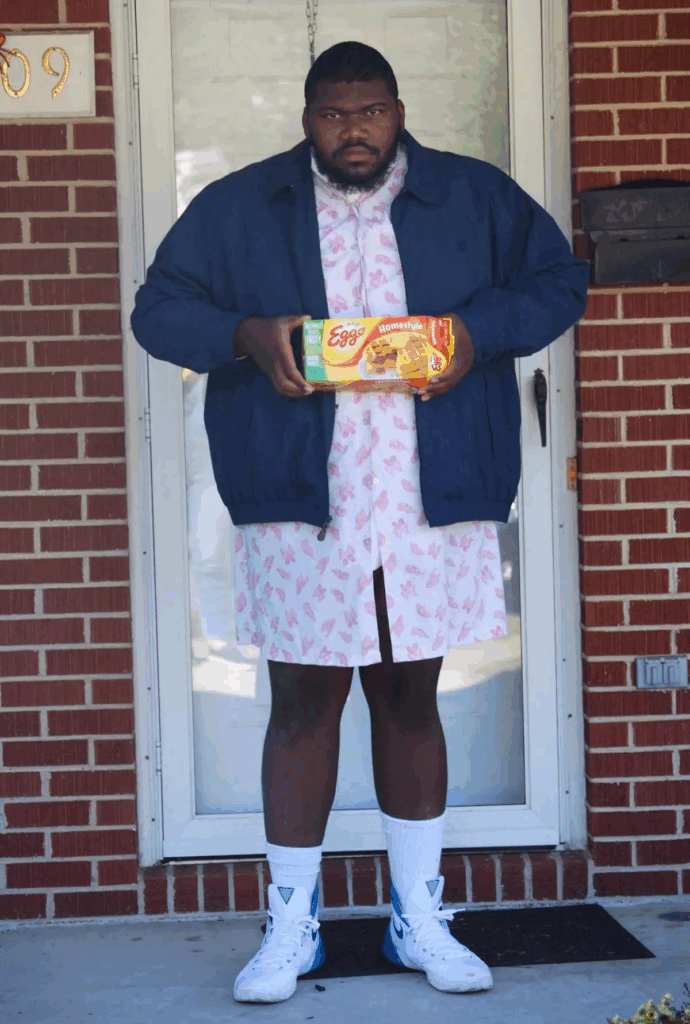 adult man holding box of Eggo waffles