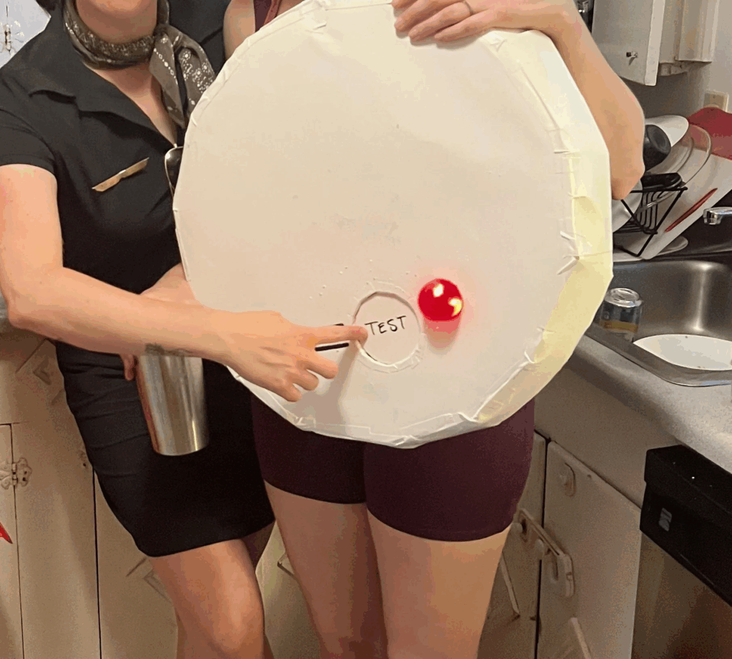 woman wearing brown outfit with smoke detector costume
