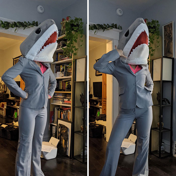 woman wearing grey pantsuit and shark hat