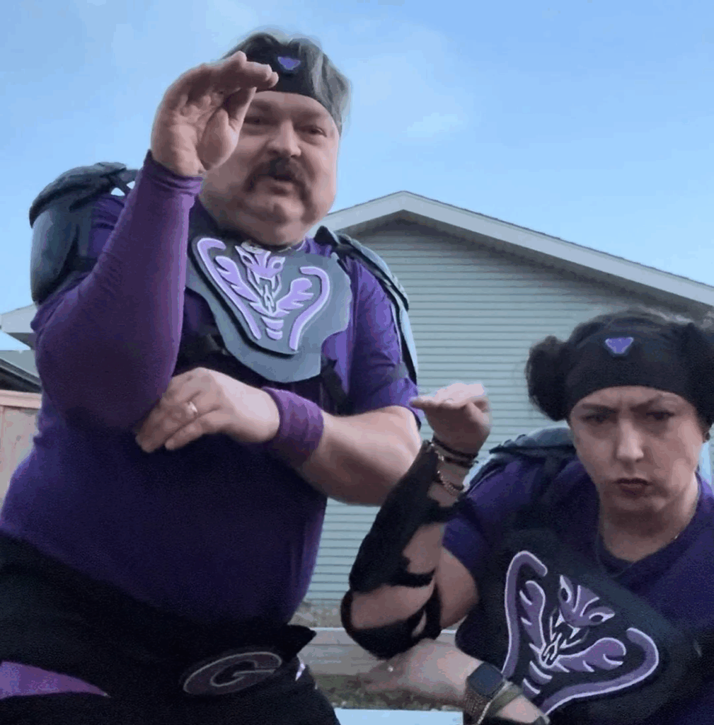 man and woman wearing purple athletic gear