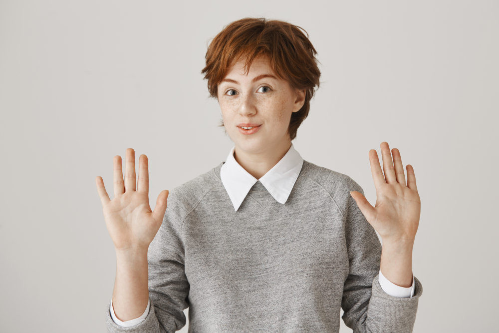 Do not involve me in your drama. Portrait of carefree clueless redhead female student raising palms and shaking head in no reply, not wanting to get in trouble or bother with someone else work