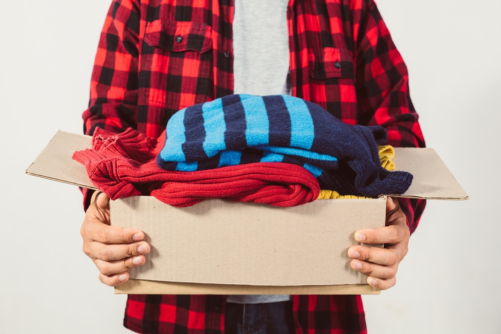 man holding box of clothes