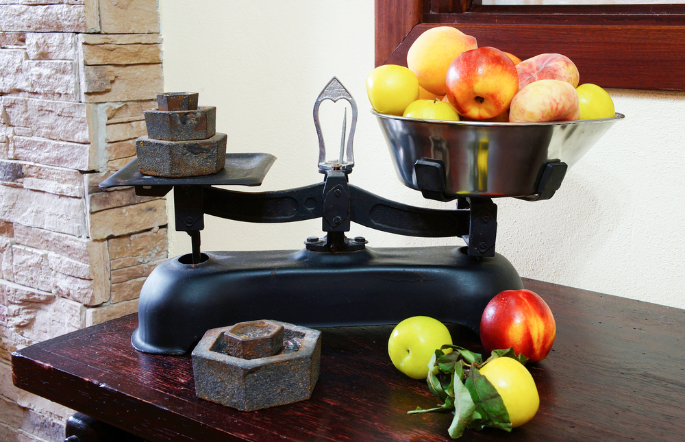 Weighing fruits on vintage scales                   