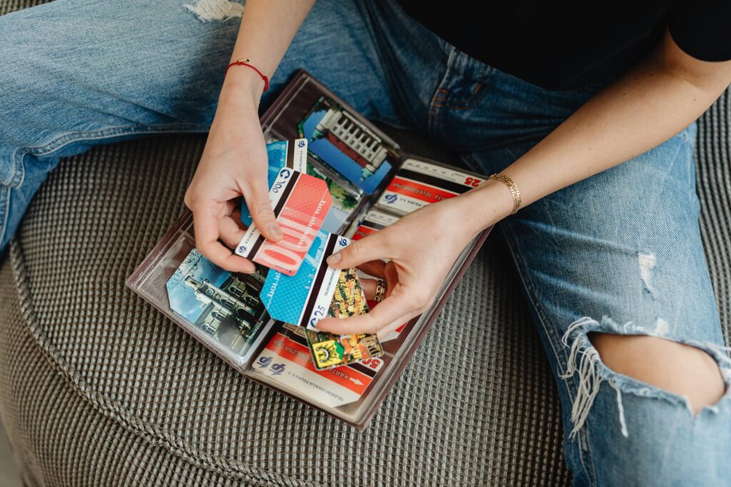 Someone going through a file of old travel cards.