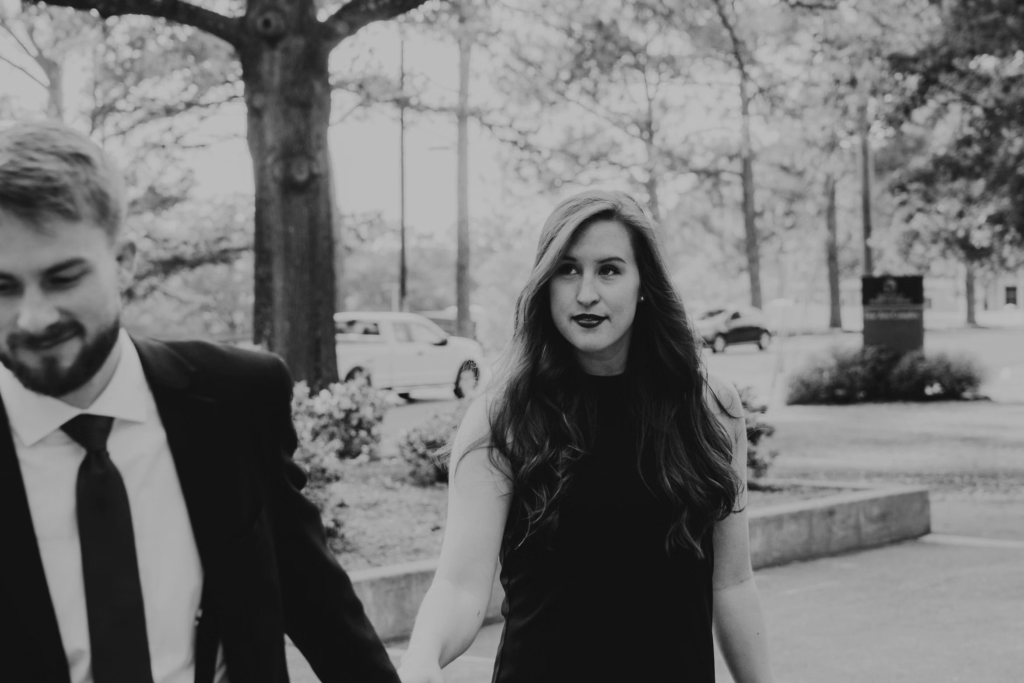 woman and man holding hands in black and white photo