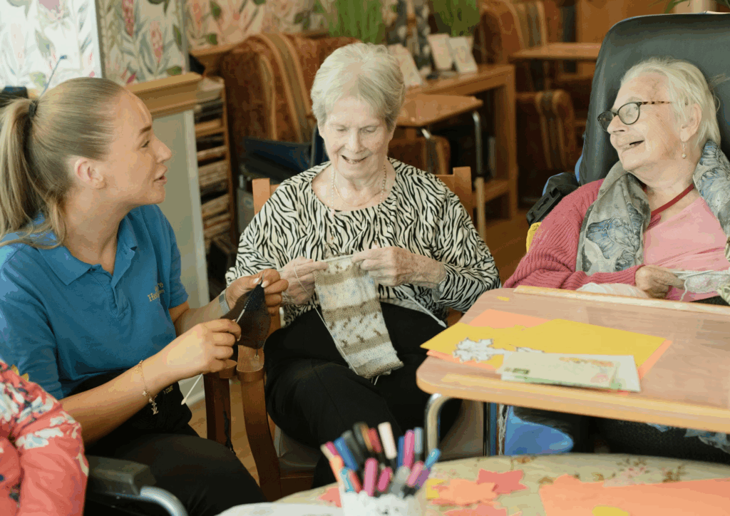 elderly people laughing while knitting