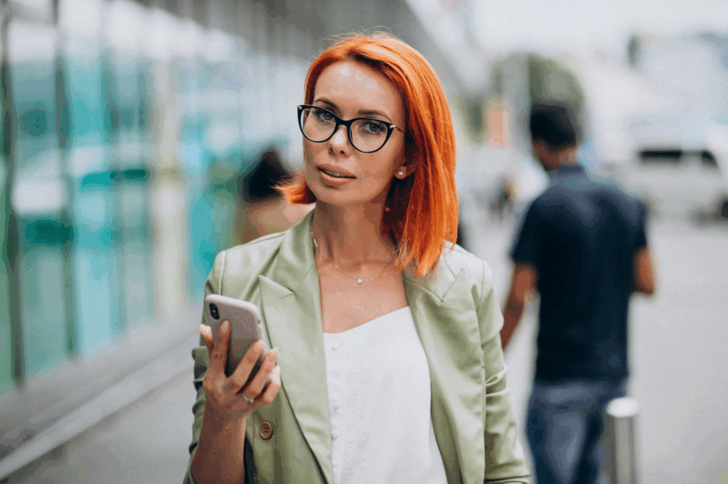 successful woman in green suit talking on the phone