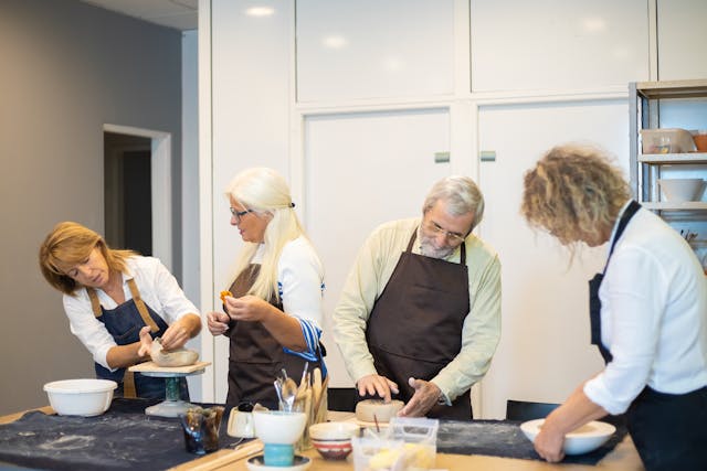 a group of elderly people working in a kitchen