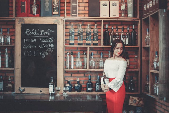 woman holding a bottle in a bar