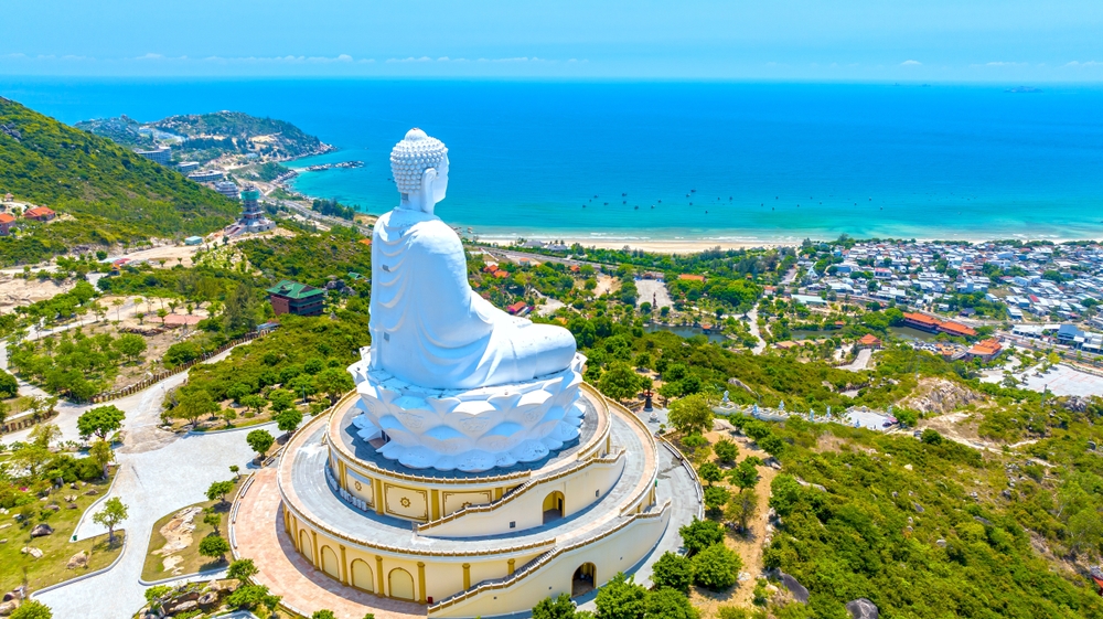 Aerial view of giant Buddha Statue on top of the mountain overlooking the sea Central Vietnam as pray good weather, smooth sea for fishermen fishing easier