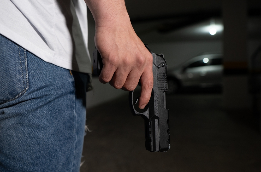 man carrying a gun down