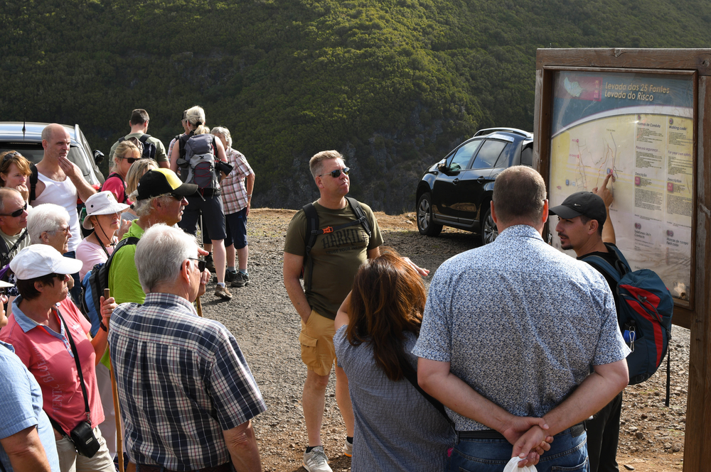 Madeira, Portugal - September 2017: A group of tourists are briefed by a guide at the start of the levada walk to the 25 Fontes and Risco waterfall