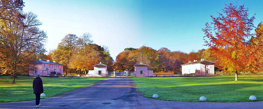 Wide view of Royal Lodge, a large estate with manicured lawns and autumn trees.