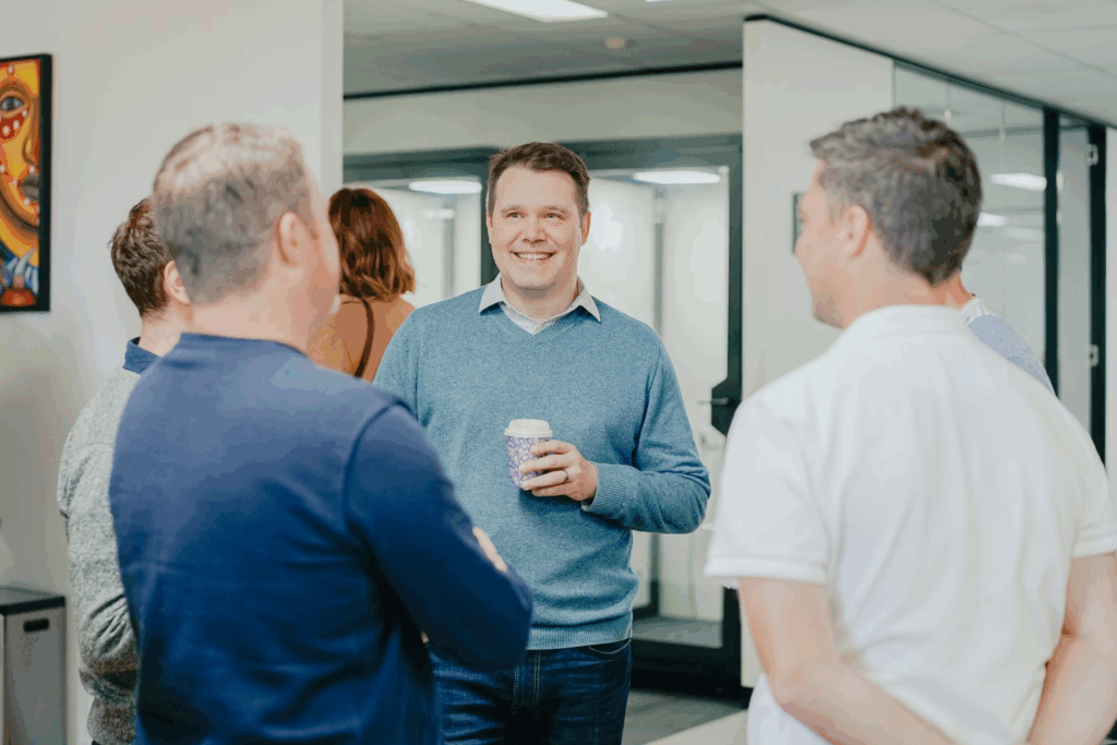 male friends standing around in an art gallery