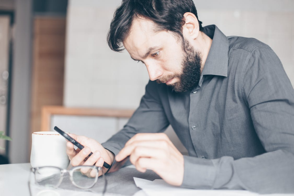 A Man Staring at His Smartphone