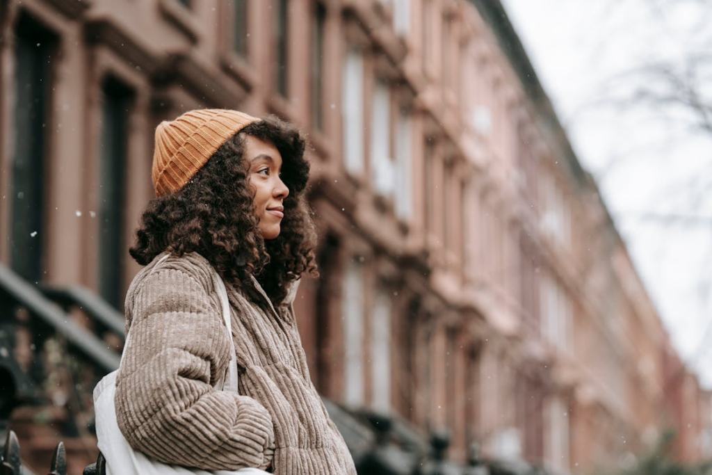 Contemplative woman on street in snowfall