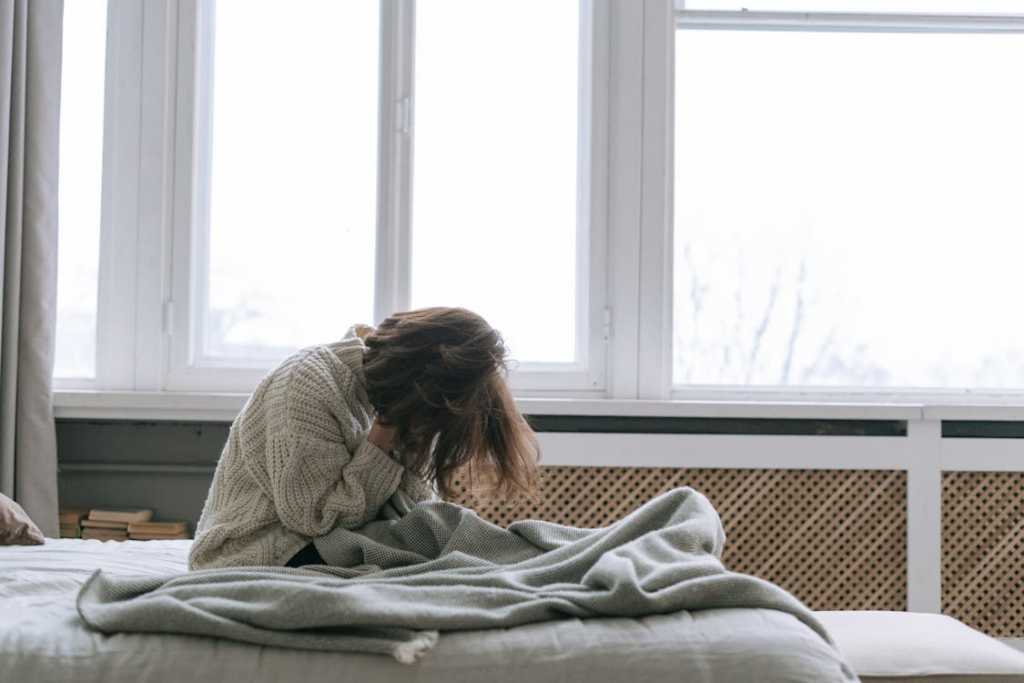 A Woman Sitting on a Bed, asking about sleeping in a deceased loved one’s bed