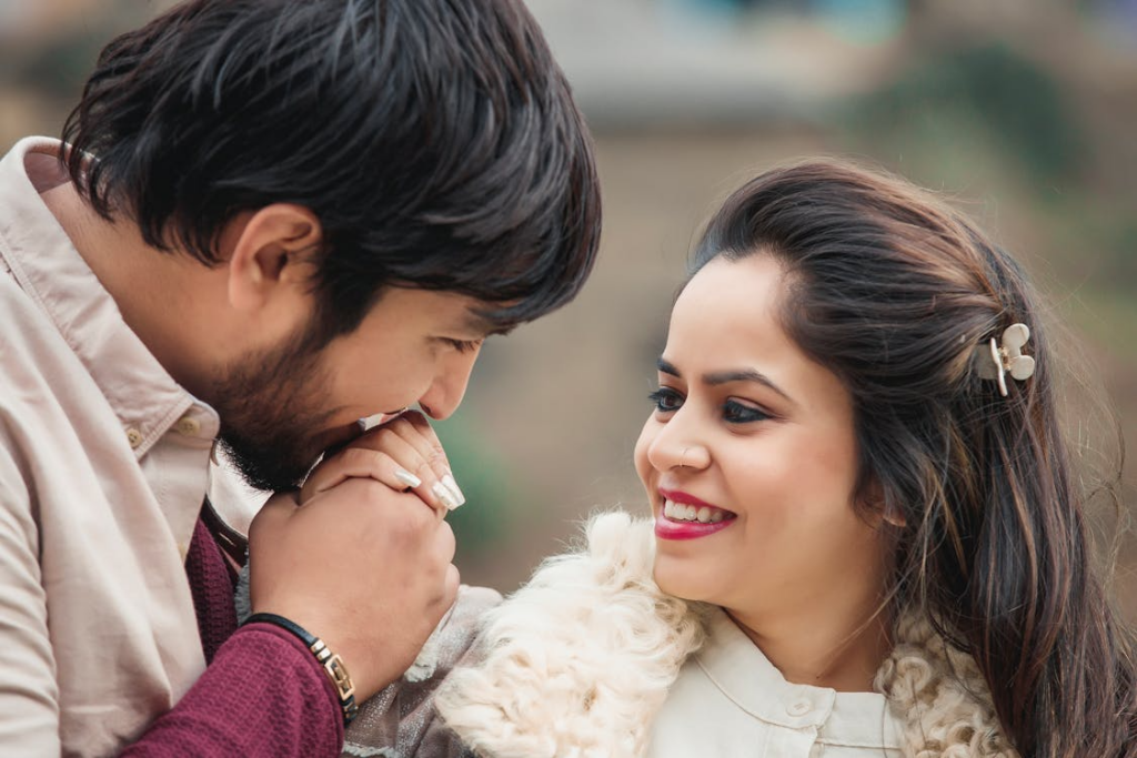 Close-up Photo of Man Kissing Woman's Hand
