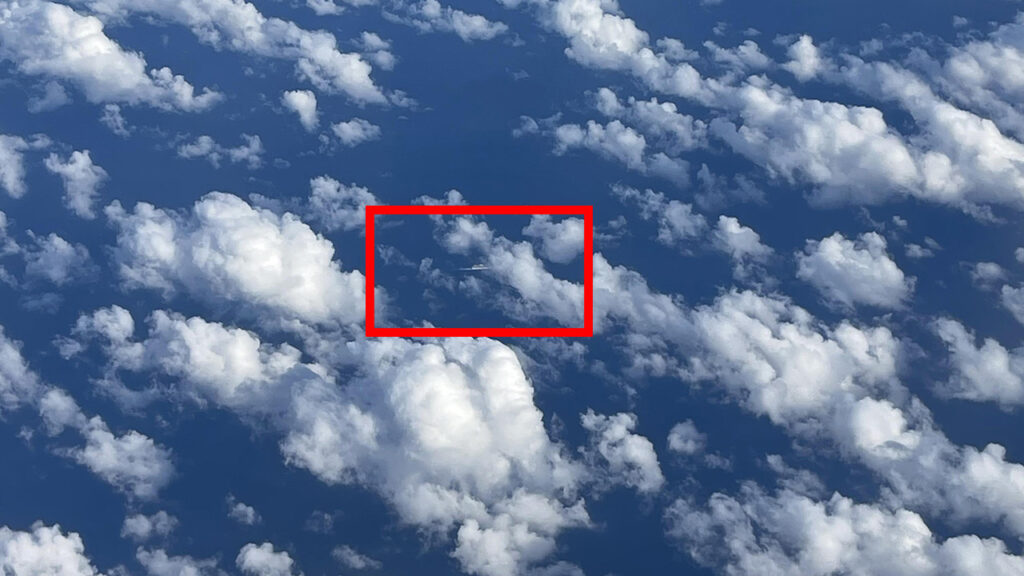 red outline showing where the hidden cruise ship is found under the clouds