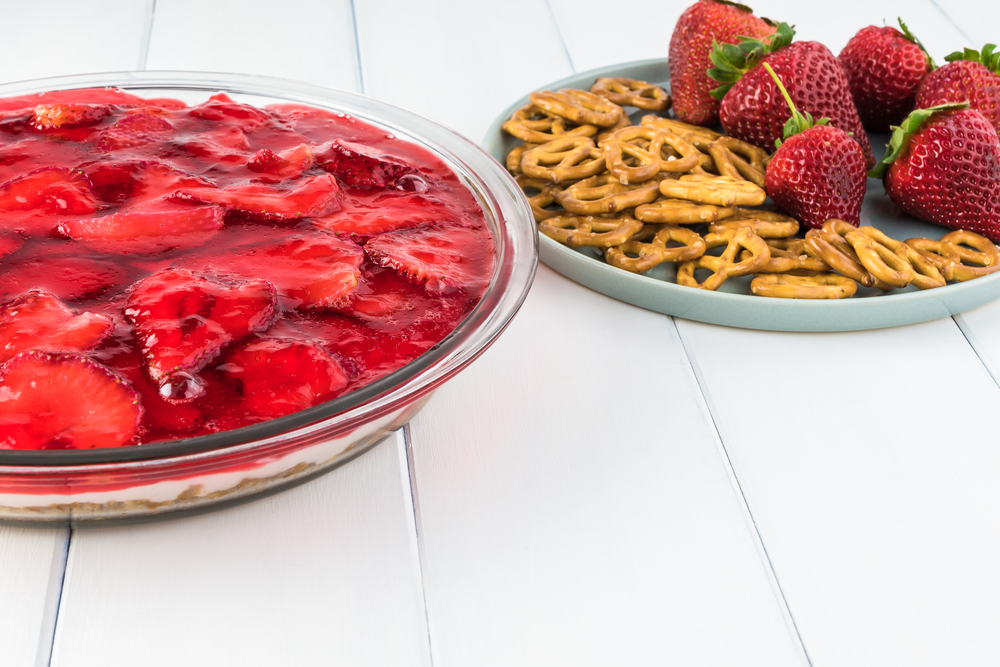 Glass bowl with homemade strawberry pretzel salad.