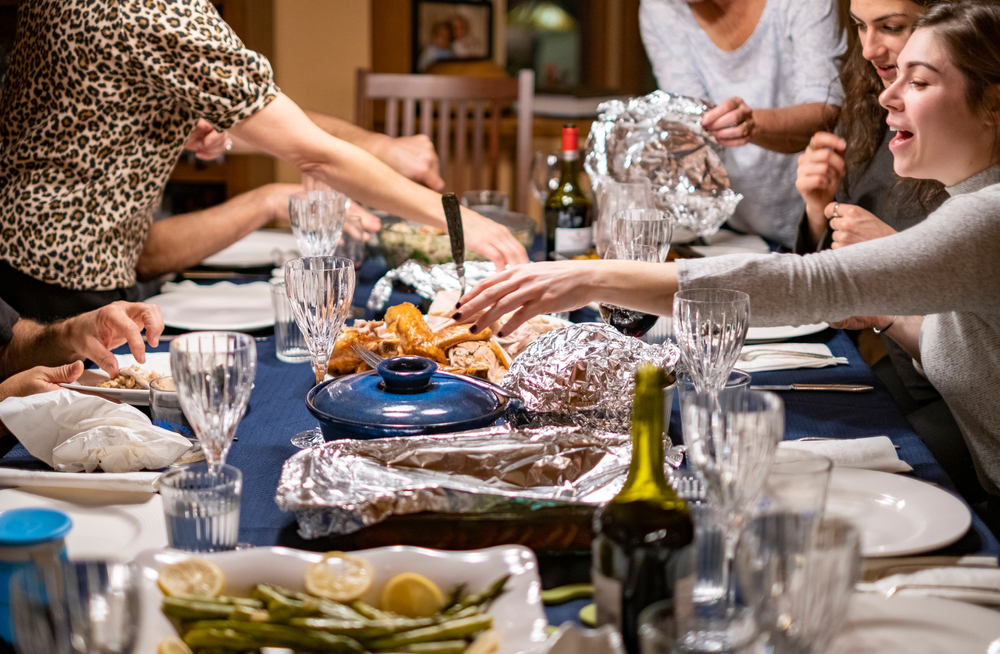 Family gathered around the Thanksgiving dinner table to celebrate the holiday