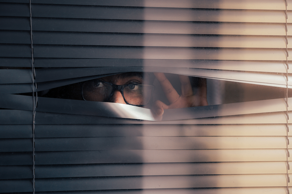 Man with glasses curiously waiting for something, person with anxiety