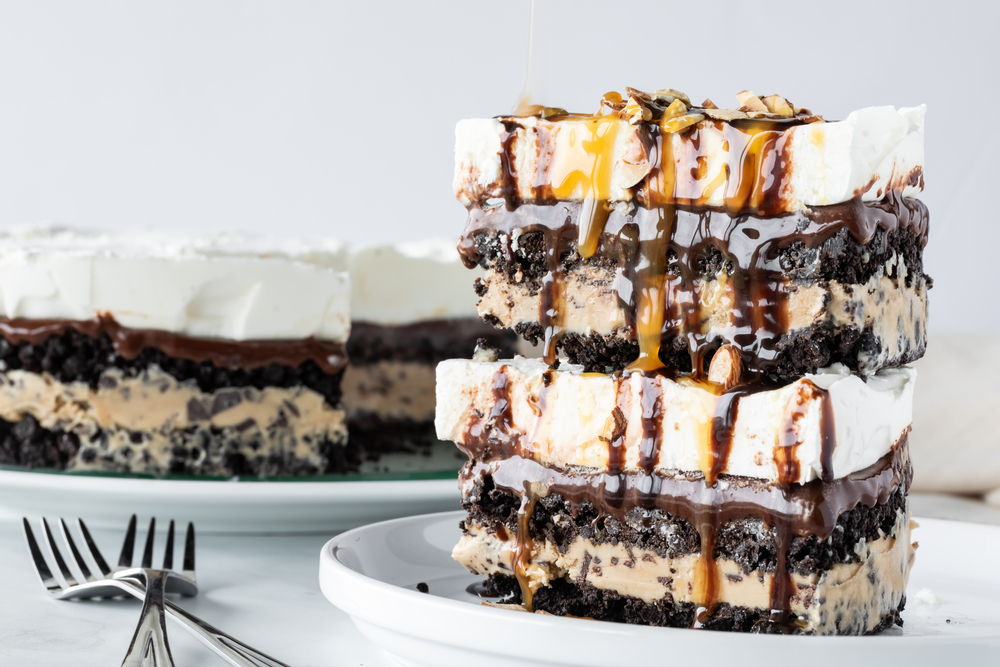 Stacked pieces of creamy chocolate, vanilla and mocha layered ice cream pie with the full pie in behind.