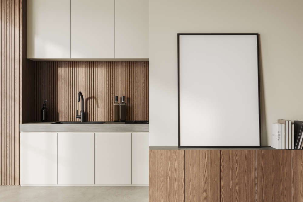 Beige kitchen interior with sink and shelves, light concrete floor. Wooden drawer with books and mock up canvas poster. Modern minimalist cooking space in apartment. 3D rendering