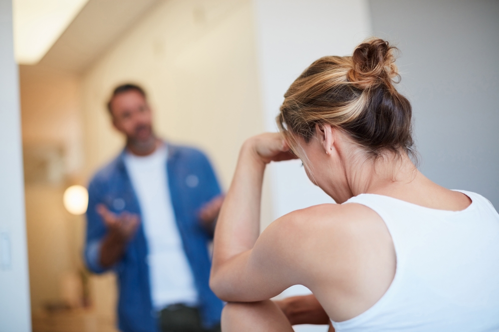Woman, couple and conflict in home with argument for disagreement, fight or cheating affair. Stress, people or frustrated for toxic relationship, marriage fail and breakup with dispute and separation