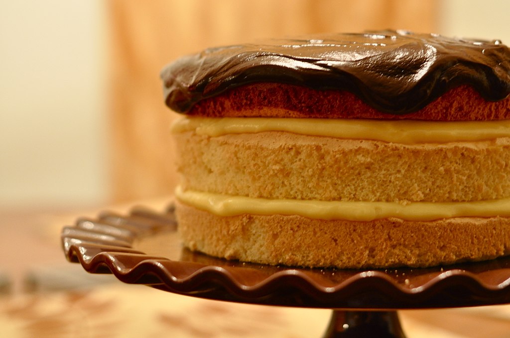 Boston cream pie with custard filling and chocolate ganache topping.