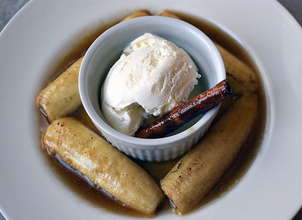Bananas foster with caramelized bananas, cinnamon stick, and vanilla ice cream.