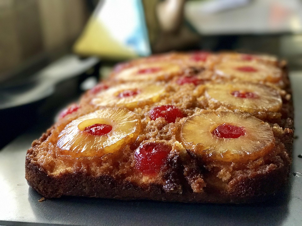Pineapple upside-down cake with caramelized pineapple rings and cherries.