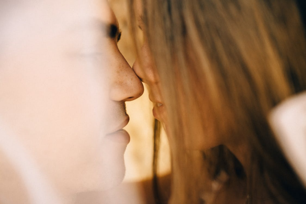 A close up of a couple having a romantic moment of closeness.