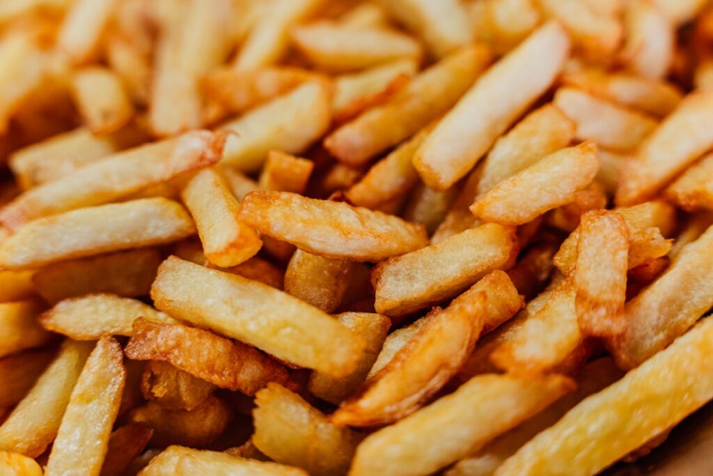 Close-up of golden french fries filling the entire frame.