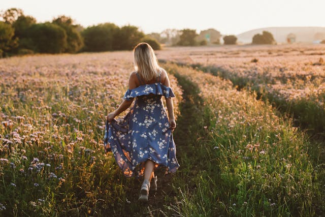 woman walking through field
