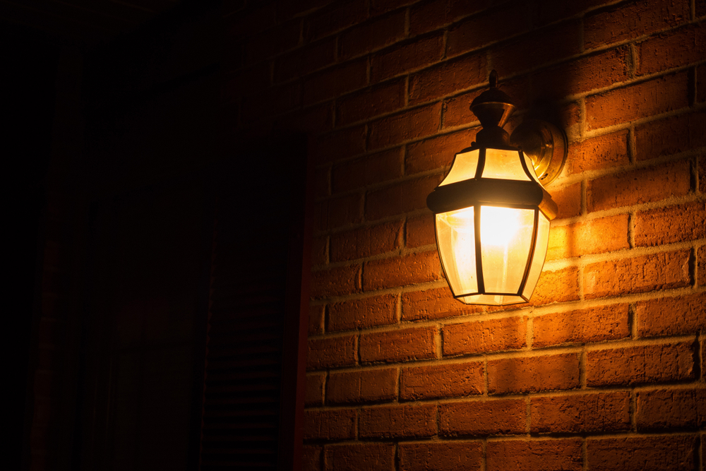 Warm light lantern illuminating the front porch at night