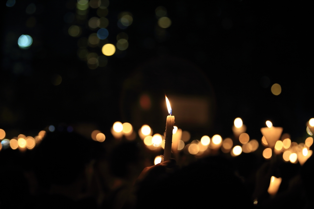 finding the light in dark. a haza candlelight vigil find each other in darkness, blur background in hong kong victoria park in 64 anniversary