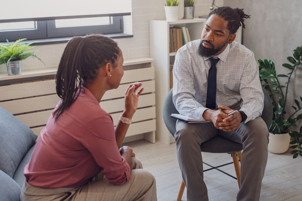 A psychotherapist session with a patient. African-American women and men have a meeting. 