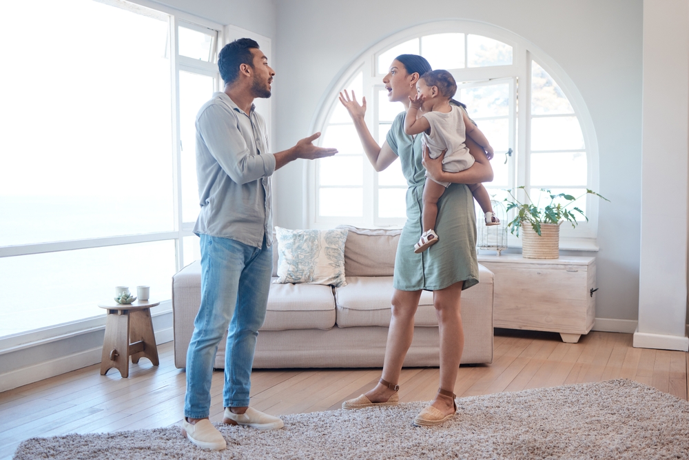 Frustrated couple, argument and fighting with baby for breakup, divorce or disagreement in living room dispute. Upset, man and woman with child in toxic relationship or conflict for affair at home