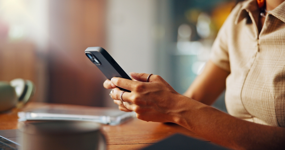 Typing, phone and hands of woman in home for social media, internet and online networking on website. Closeup, relax and person on smartphone for chatting, connection and communication on mobile app