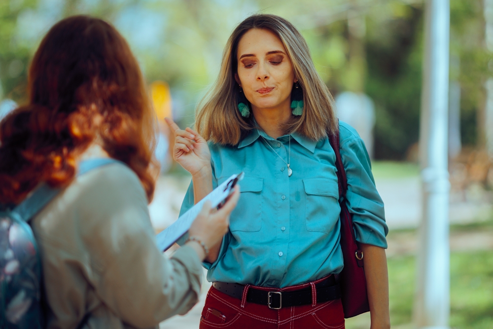 Woman Refuses to Answer an Opinion Poll on the Street 
Reluctant person does not want to participate in a street fundraising  
