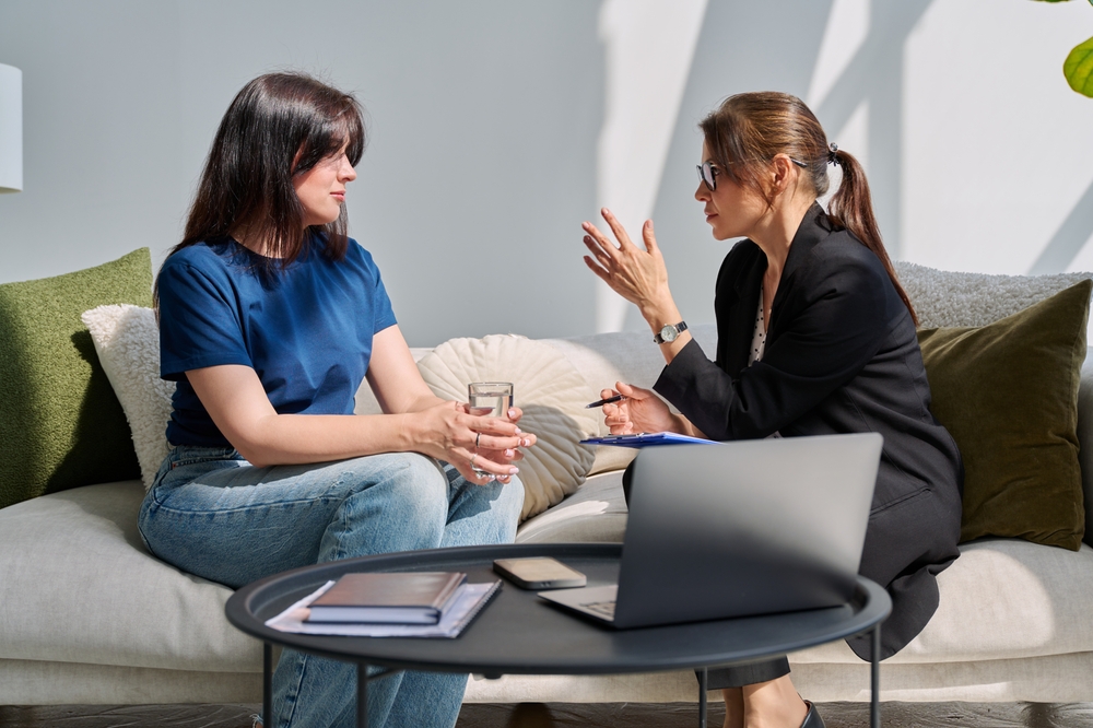 Mental therapy session, young woman patient talking to professional psychologist