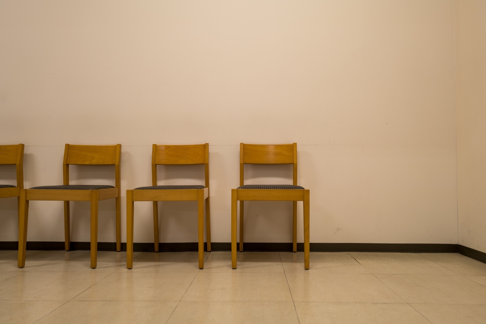 Wooden Chairs Aligned in a Quiet Waiting Room