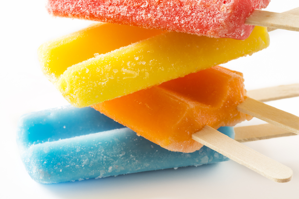 Closeup of colorful twin pops on a white background.