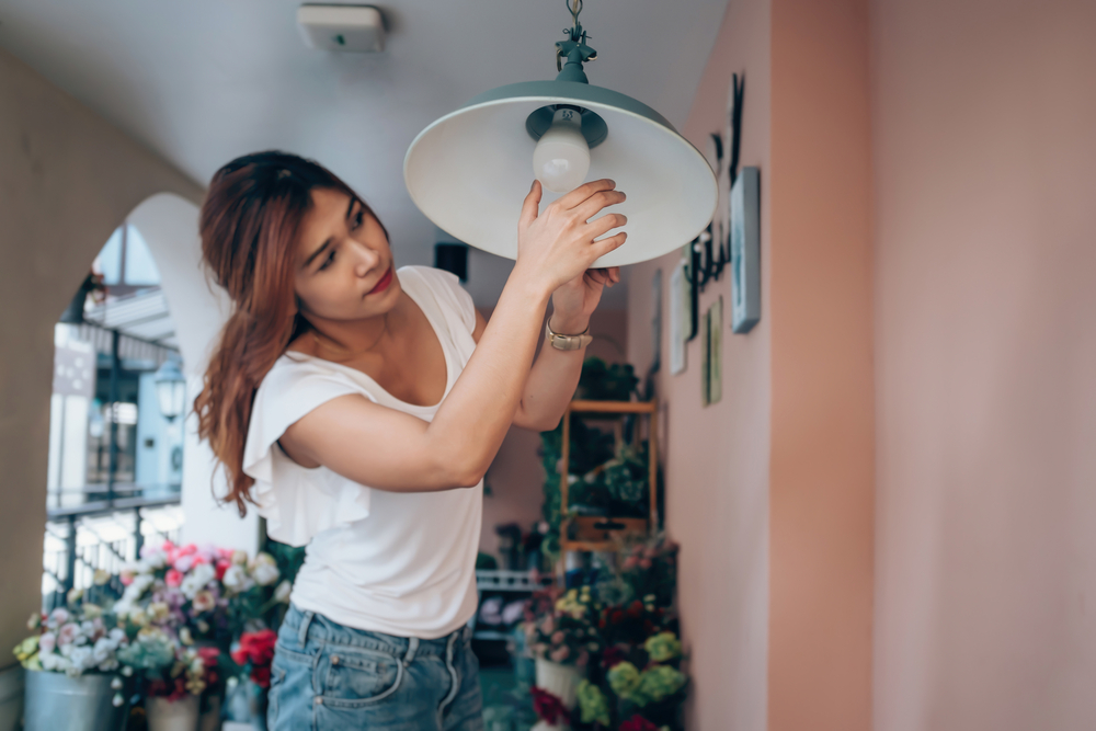 Women who owns a flower shop Are changing bulbs Photo Focus on the hands of women.